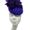 Stunning purple felt base headpiece with irridescent blue embelished detail and finished with stunning hand made silk flower details.